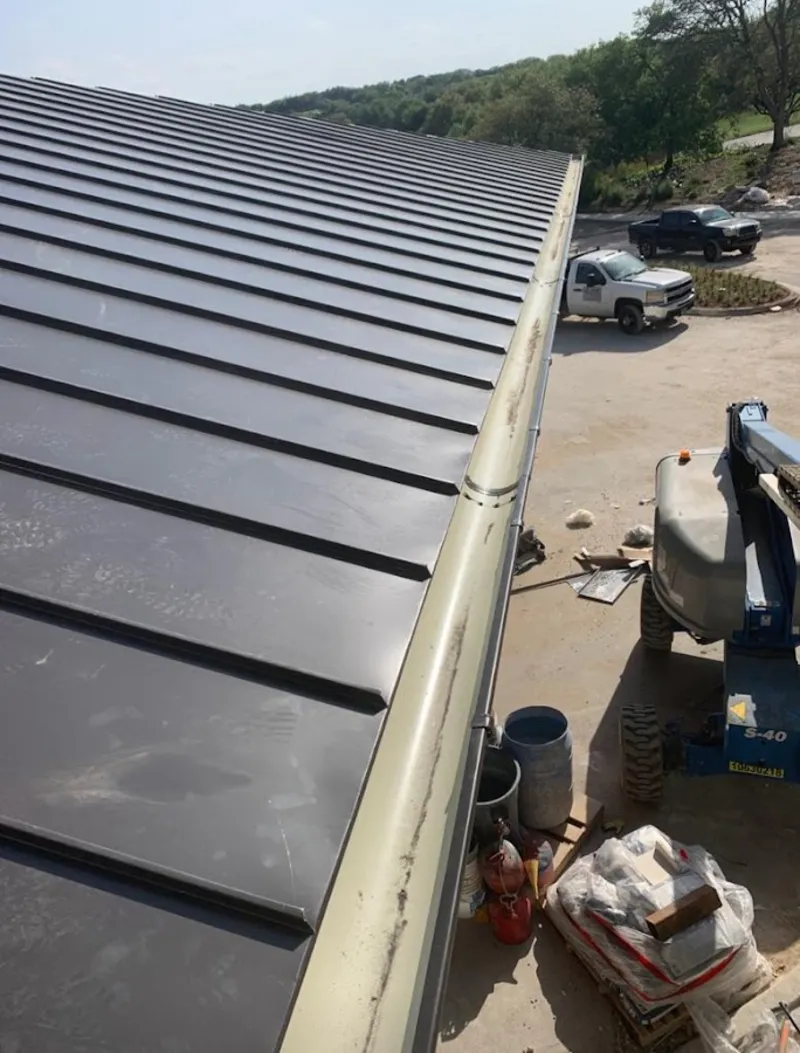 Standing seam panel and gutter detail on a metal roofing jobsite in Taylor Mill